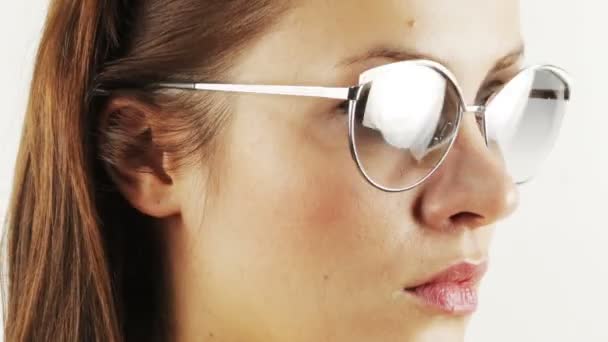 Stopmotion of a pretty woman wearing different retro sunglasses — Stock Video