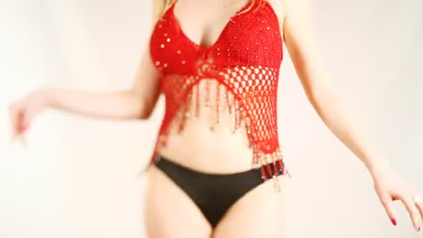 Beautiful young blond woman dances in oriental style red top — Stock Video