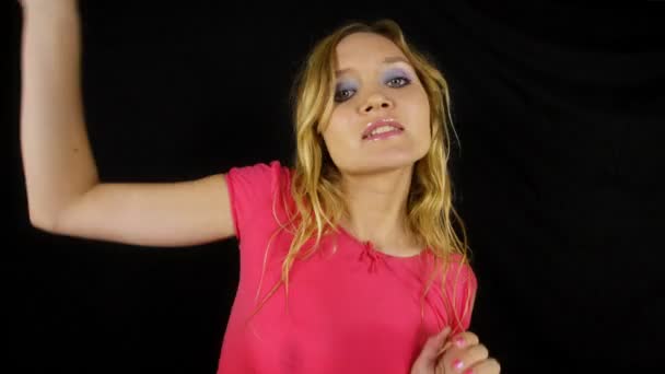 Beautiful young blond woman dances in tight top — Stock Video