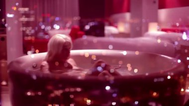 gül yaprakları ile dolu bir büyük otel banyoda seksi ve güzel bir kadın