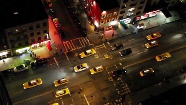 Looking down onto a new york street of fast moving traffic at night — Stock Video