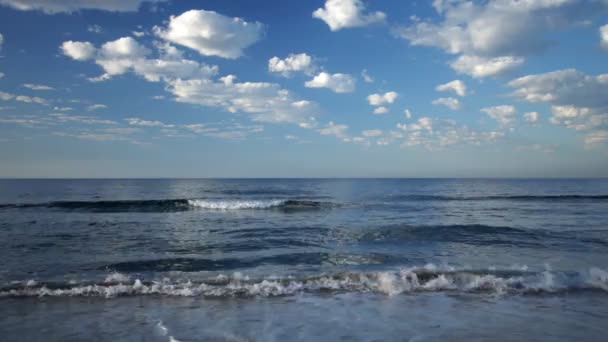 Волны плещутся на пляже на восходе солнца — стоковое видео