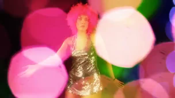 En sexig kvinna dansar med rosa galen frisyr — Stockvideo