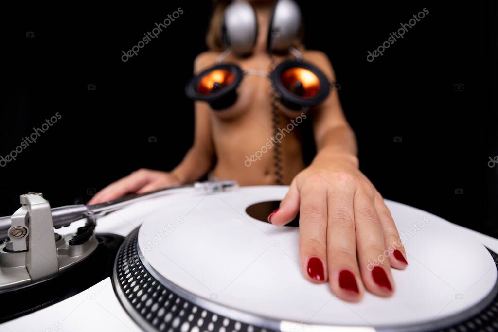 Disco woman with speakers on her body and headphones Djing