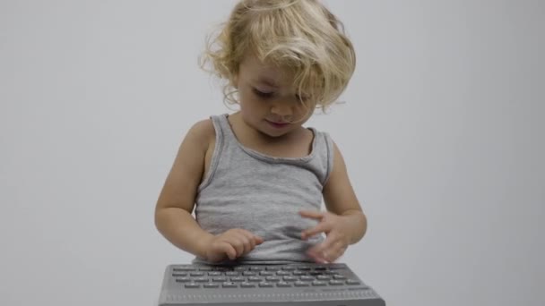 Small girl typing on keyboard — Stock Video