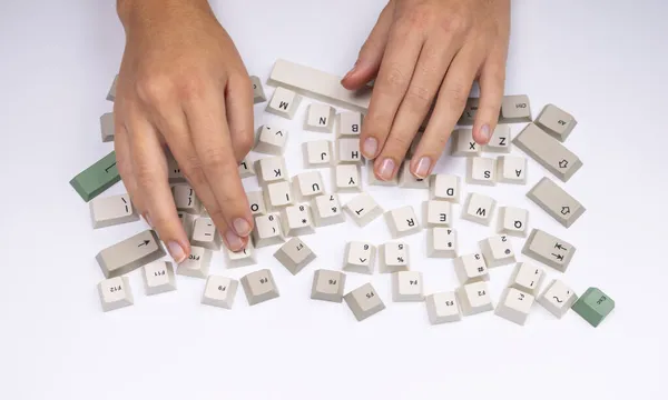 Loose keyboard keys with hands typing — Stock Photo, Image