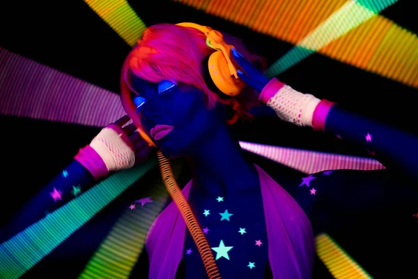 Female dancer in glow UV costume — Stock Photo, Image