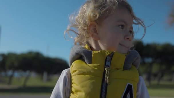 Крута маленька дівчинка в жовтій куртці — стокове відео