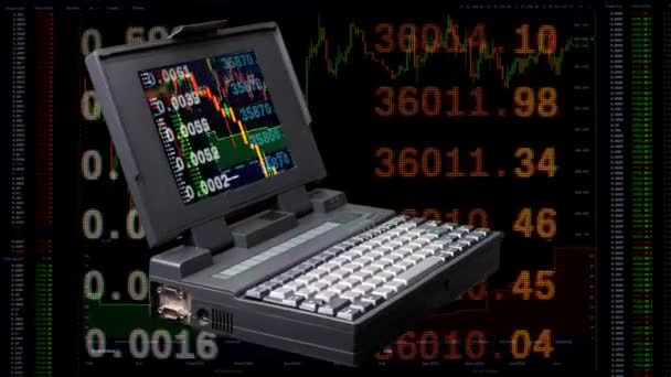 Vintage laptop spinning with stock trading on screen — стоковое видео