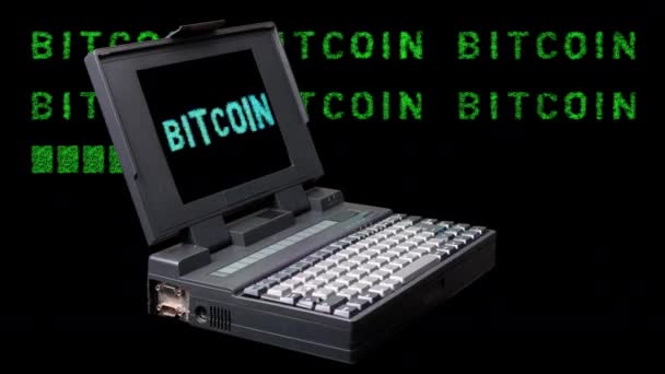 Vintage laptop spinning with bitcoin word on screen — Video Stock