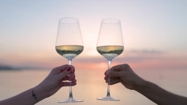 Hands making cheers with wine in glass against the sea — Vídeo de Stock