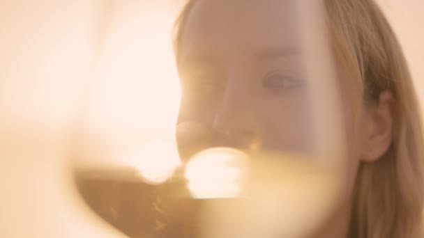 Woman holding a wine in glass against the sea — Vídeo de Stock