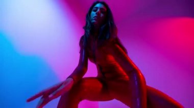 Female dancer posing against colourful background