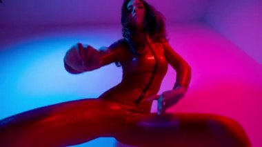 Female dancer posing against colourful background