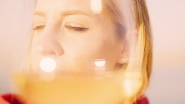 Woman holding a wine in glass against the sea — Video Stock