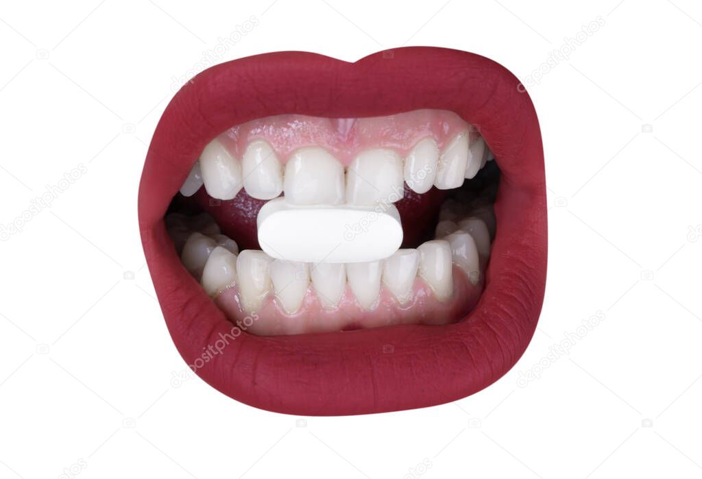 Womans beautiful full red lips with white pill in between the teeth 