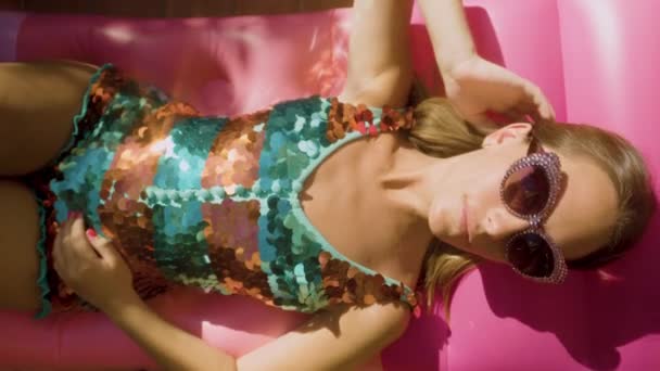 Pretty Woman Sparkling Bikini Sunbathes Inflatable — Stock Video