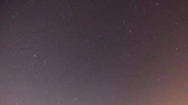 A night time timelpase of stars moving across the sky