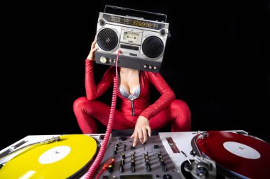 A female dj playing with a ghettoblaster for a head dancing with turntables 