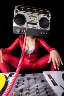A female dj playing with a ghettoblaster for a head dancing with turntables 