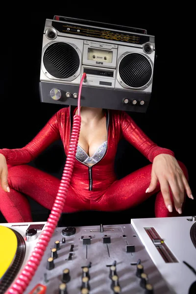 A female dj playing with a ghettoblaster for a head dancing with turntables