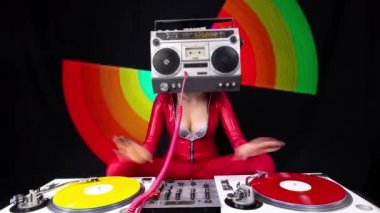 A female dj playing with a ghettoblaster for a head dancing with turntables 