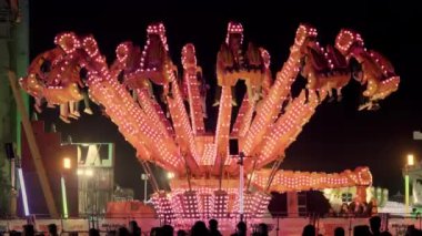 Rides at a funfair in barcelona at night