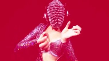 Amazing female dancer with spiked mask against black background