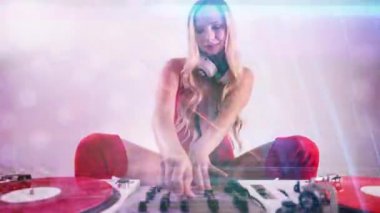 Beautiful female dj in red outfit playing with turntables with overlayed disco lighting