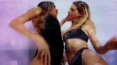 Two beautiful female disco dancers moving with heavy glitch and distortion