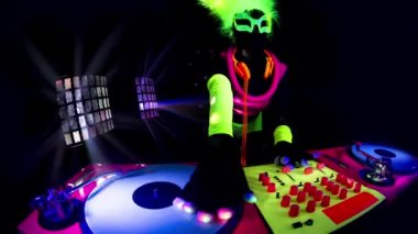 A mix of different cyber raver dancers and Djs filmed in fluorescent clothing under UV black light