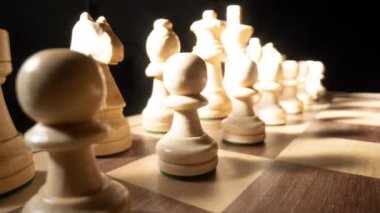 A macro shot of a shadow moving across a chess board repeating forwards and backwards 