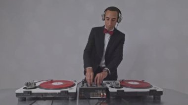 Havalı bir Djing şık bir takım elbise giyiyor.