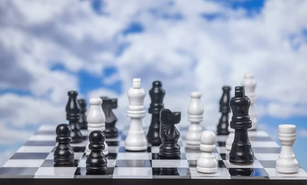 A game of chess with passing clouds behind