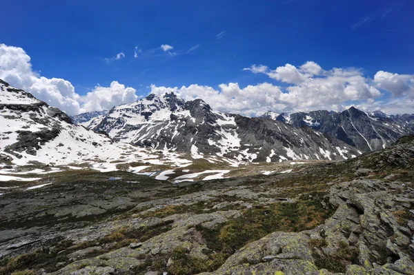 Summer in mountain with snow clouds in the sky — Stock Photo, Image