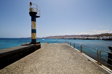 lighthouse and pier boat in the blue sky arrecife teguise clipart