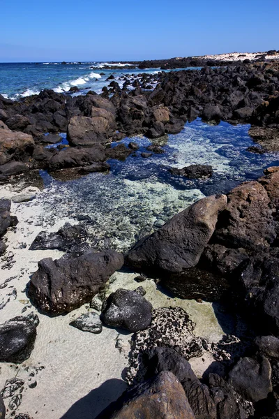 Sky light beach water in lanzarote isle foam rock spain — Stock Photo, Image