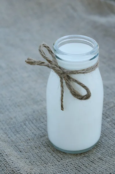 Bottle of milk on canvas background — Stock Photo, Image
