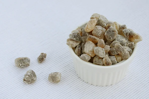 Brown sugar crystals on light background — Stock Photo, Image