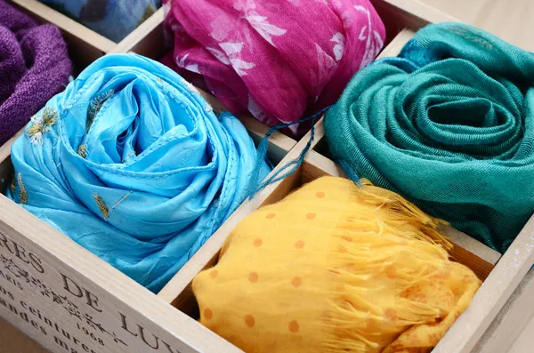 Set of colorful scarfs in wooden box — Stock Photo, Image