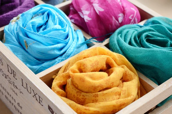 Set of colorful scarves in wooden box — Stock Photo, Image