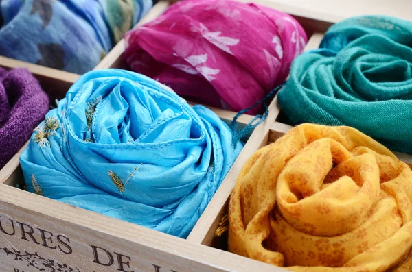 Set of colorful scarfs in wooden box — Stock Photo, Image