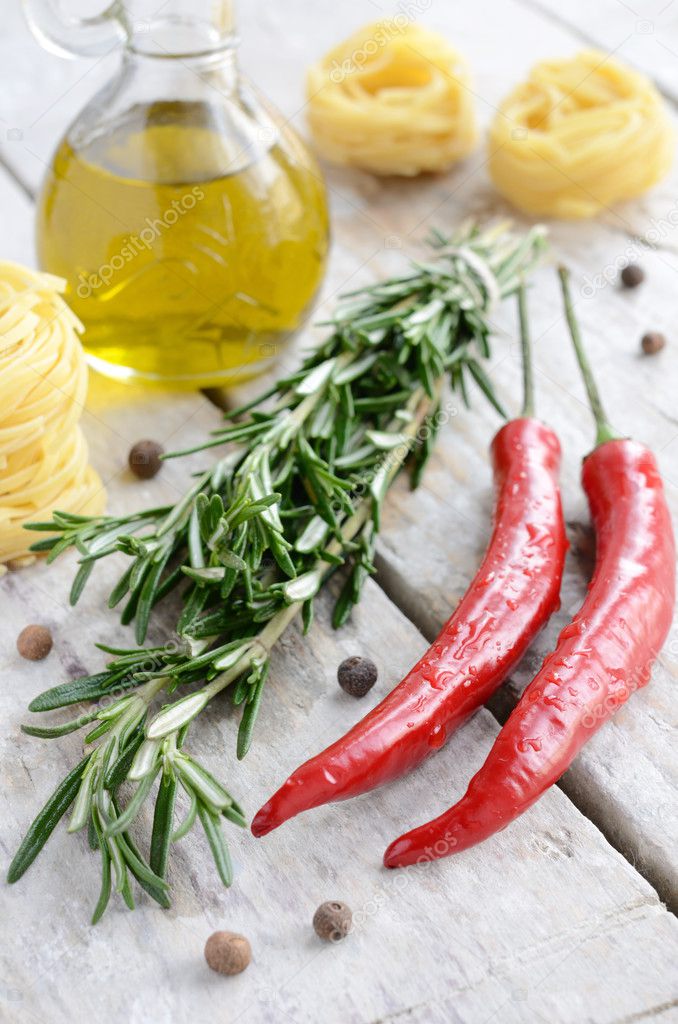 Italian ingredients - rosemary, olive oil, chilli, raw tagliolin