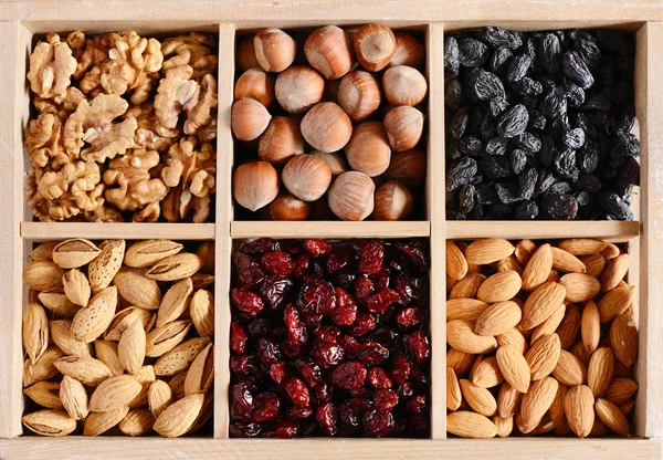 Nuts and dried fruits mix in wooden box — Stock Photo, Image