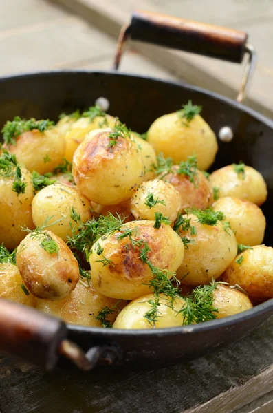 Whole fried potato in old wok — Stock Photo, Image