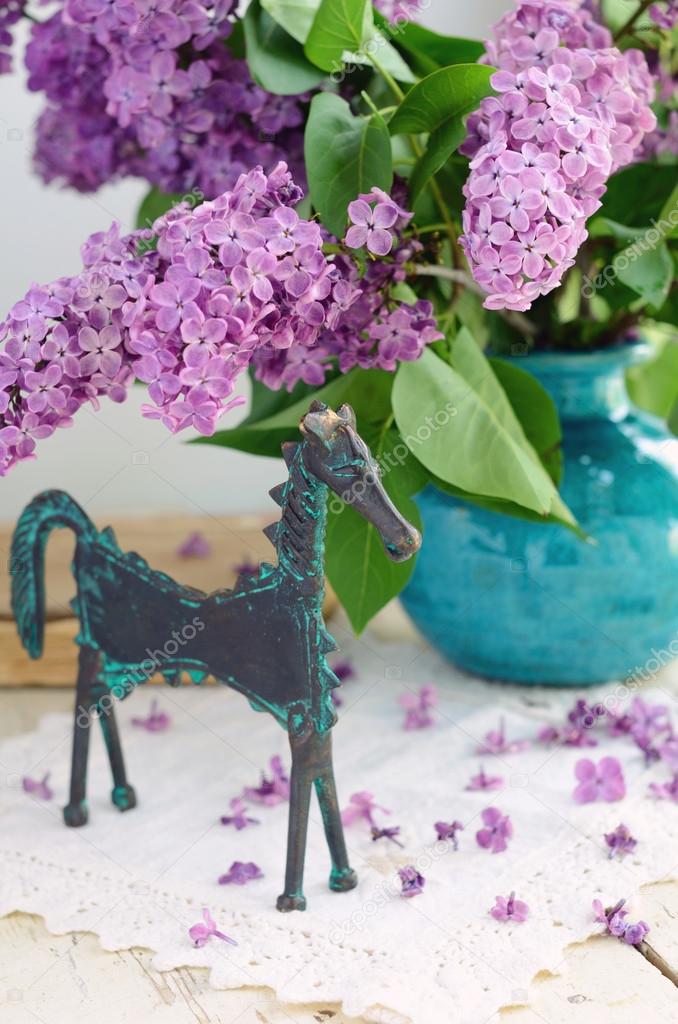 Decoration with horse statuette and lilac