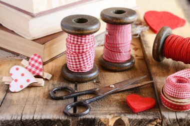 Decoration with wooden spools and red ribbons clipart