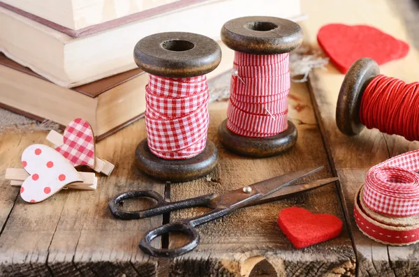 Decoration with wooden spools and red ribbons — Stock Photo, Image