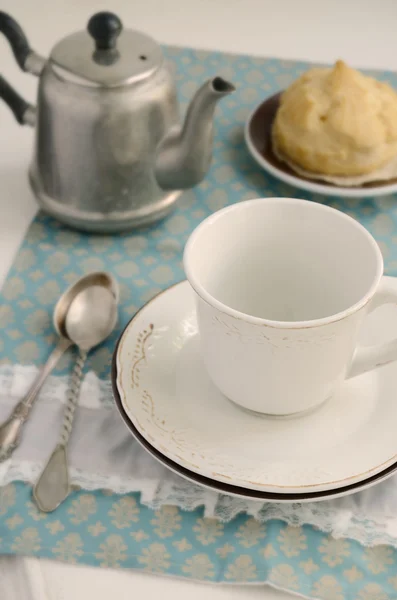 Teatime with eclair on lace napkin — Stock Photo, Image