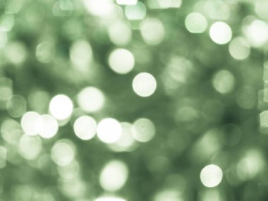 Green background with abstract spots of light, photo toned, bokeh